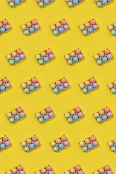 Bright seamless Easter template with white eggs in carton boxes on yellow background