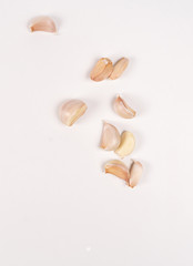 garlic lies on a white table. white background