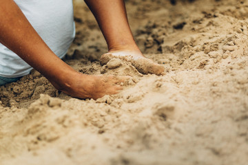 female feet in beach sand