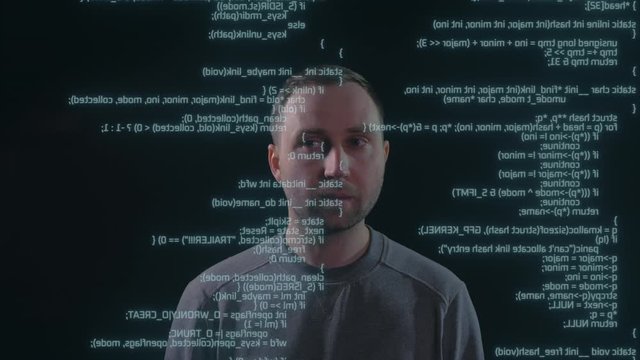 Programming data, code, text, script on the screen in front of the man. Cyber security concept.
