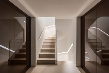 Modern interior of empty light hall with stairs and mirrored walls in contemporary city building