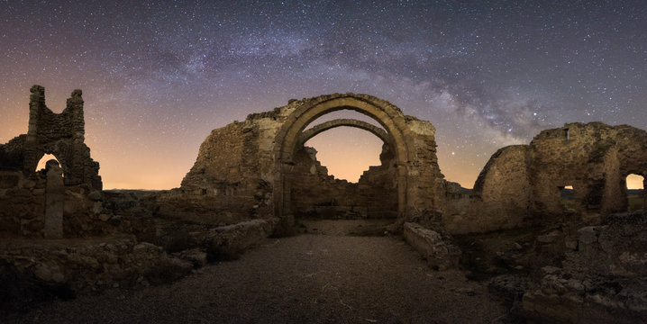 Remains of ancient castle under Milky Way at starry night