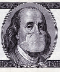 COVID-19 Coronavirus pandemic in the USA, $ 100 cash note with face mask. Virus outbreak had slowed...