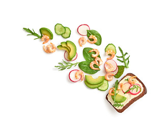 Open sandwich avocado, shrimp, cucumber, cheese flying. Homemade smorrebrod with spinach, rye bread isolated on white background. Levitation fly shrimp sandwich creative cook concept