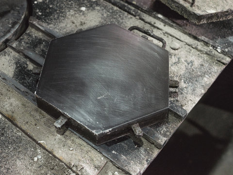 From above of big metal hexagonal form for casting of tiles in modern factory
