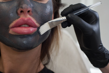 applying a black mask with a brush