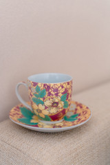 porcelain tea cup on textile background