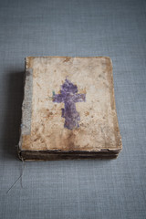 A very old Bible that has survived to this day. Photo of the book on top. Vertical format
