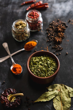 Top view composition with different kinds of natural aromatic spices placed on slate surface background