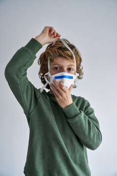 Blond boy, about 8 years old, wearing a respirator to co-infect himself with a virus