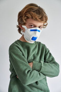Blond boy, about 8 years old, wearing a respirator to co-infect himself with a virus
