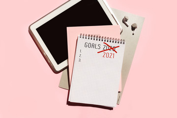 Notepad page with strikethrough goals for 2020. Quarantine. Concept for changing plans for the coronavirus pandemic. Isolation, stay home, change plans, lost 2020