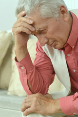 Portrait of thoughtful senior man at home