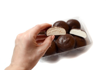 marshmallows in chocolate, sweets on a background with a mug of coffee