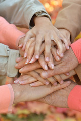 Cropped image, family putting hands together close-up 