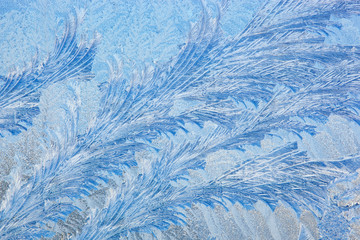 Close-up of a frost pattern on window glass formed on a frigid winter morning