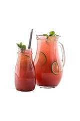 Fresh Lemonade with Watermelon and Lime in glass and pitcher isolated on white background