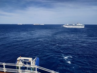 Bimini, Bahamas - 23 April 2020: meeting cruise ships in open sea to exchange provision and transferring crew