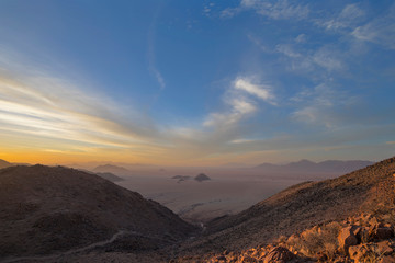 Naklejka na ściany i meble Sunset during dust storm in the Namib Desert