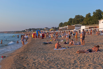 Uchkuevka beach in the rays of the setting sun in the city of Sevastopol, Crimea
