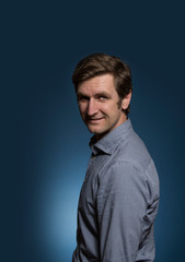 Man in Dress Shirt with Head Turned Towards Camera