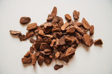 Granulated pine bark of medium fraction for planting Phalaenopsis Orchid close up on a white background