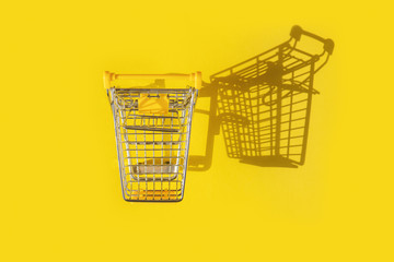Shopping cart on yellow background.