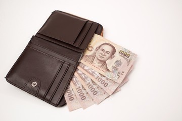 Thai currency banknote, Five Thousand baht in old wallet on white background