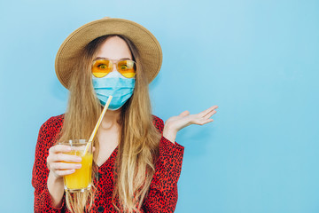 girl in a dress, hat and sunglasses with a medical mask on her face. Quarantine holiday concept. Vacations in the epidemic of coronavirus. Self-isolation with covid 19