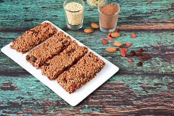 Healthy breakfast bars with puffed quinoa, cocoa powder, almond butter, goji berry, raisin, maple...