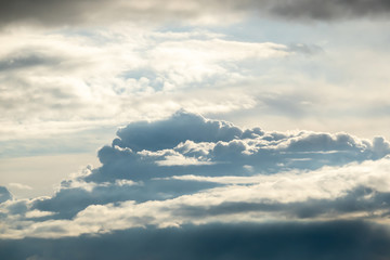 The sky after the rain with Cumulus clouds and a sun gap between them.