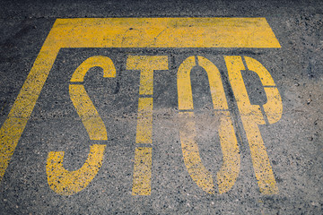 Stop road sign drawn on the asphalt.
