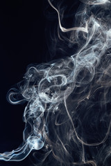 Beautiful white smoke on black background. Movement of abstract smoke on dark background