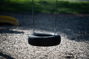Children's swing on a background of grass close-up.