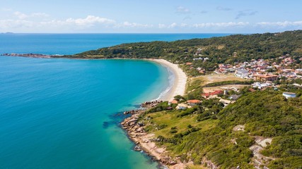 Fototapeta na wymiar Aerial view of Cima beach, in Palhoça. Beautiful beach among green mountains in Santa Catarina, Brazil