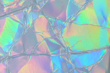 Blurred abstract Modern pastel colored holographic background in 80s style. Crumpled iridescent...