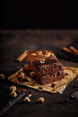 brownie cake wit hazelnut and chocolate on dark grunge table