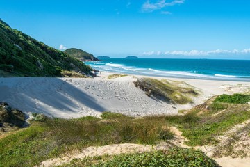 Deserted beach behind the mountain in Guarda do Embaú. Beautiful beach among green mountains in Santa Catarina, Brazil