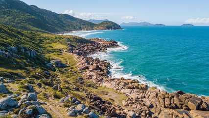 Beautiful landscape of rocks and green mountains on the Prainha trail in Guarda do Embaú, Santa Catarina, Brazil © Jair