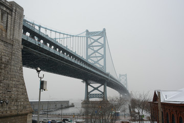 PHILADELPHIA, PENNSYLVANIA, USA - MARCH 19, 2018: View of Ben Franklin Bridge in snowy and foggy weather
