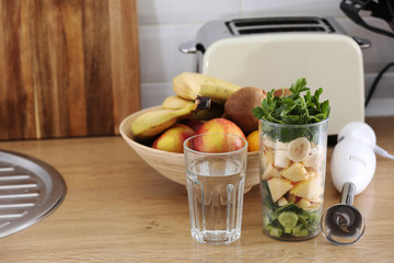 crushed fruit for smoothie. Different tropical fruits and smoothie on table on home kitchen background, healthy eating lifestyle concept. selective focus.