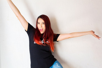 Hispanic white-skinned redhead woman dancing cheerful and happy, positive attitudes concept on a...