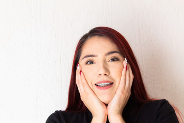 Hispanic white-skinned redhead woman showing a cheerful smile, positive attitudes concept on a...