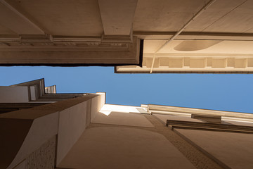 Bottom view of the white townhouse and the blue sky