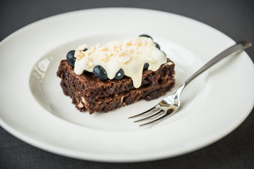 Chocolate brownie with berry sauce, blueberries