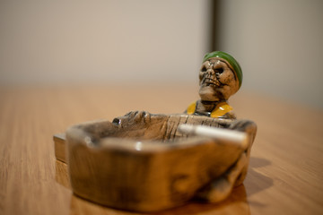 An ashtray designed as skull skeleton head - skull skeleton head in selective focus