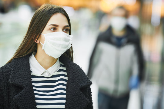 woman with protective face mask at public place. corona virus outbreak