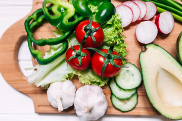 Still life of fresh organic vegetables on wooden plate, selectiv