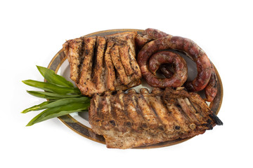 meat plate with oven-baked ribs and sausages. meat plate for the holiday table. meat dishes for the menu.