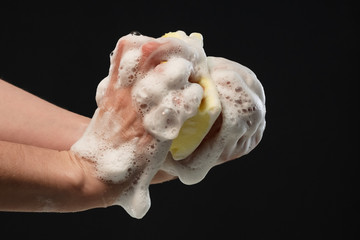 Hand washing with a washcloth with foam under running water during covid - 19. Close-up.